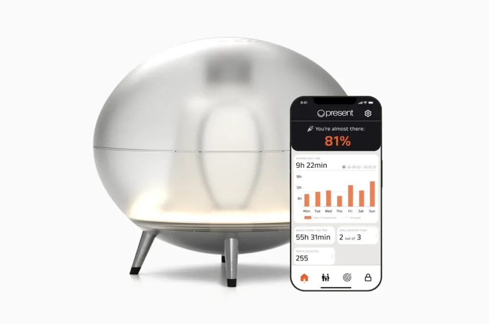 The Oval docking station beside the Present app on a phone.