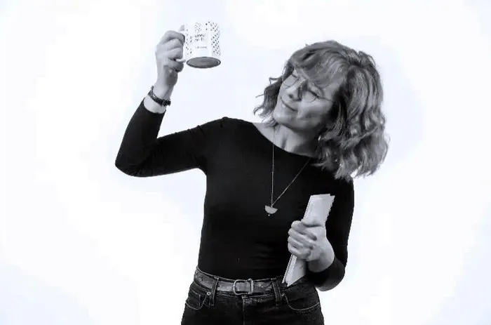 A colleague raising a mug to the camera.