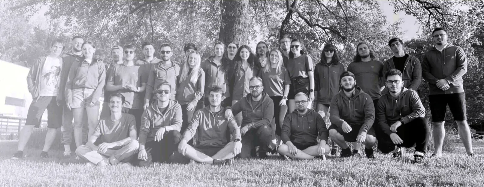 The Salt & Pepper team together outdoors under the trees.